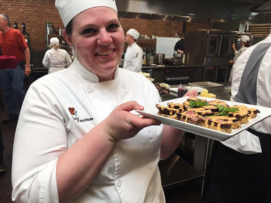 A Park City Culinary Institute student showing the beef she has prepared.