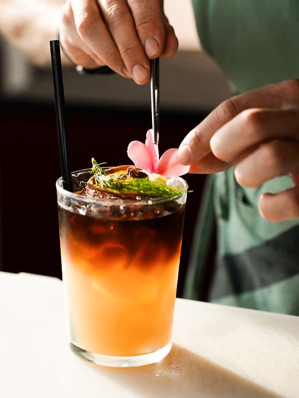 Photo of a cocktail being garnished.