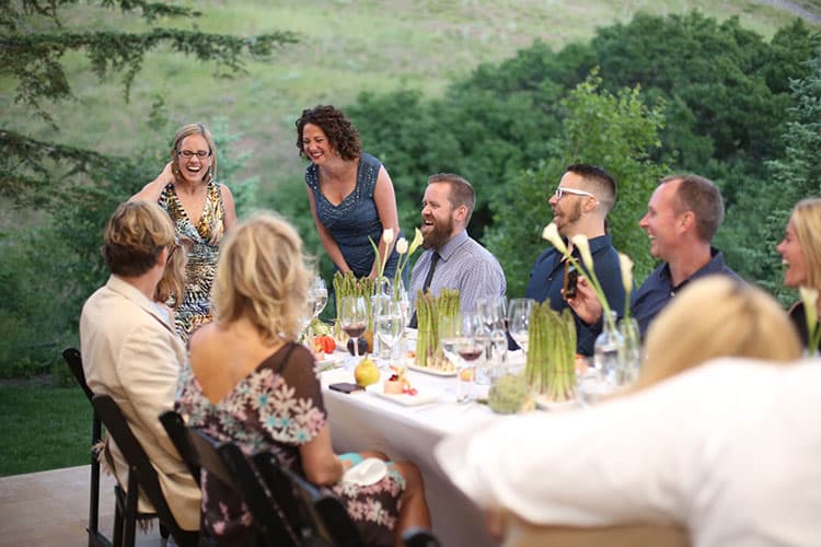 Guests having fun out an outdoor banquet catered by Park City Culinary Institute.
