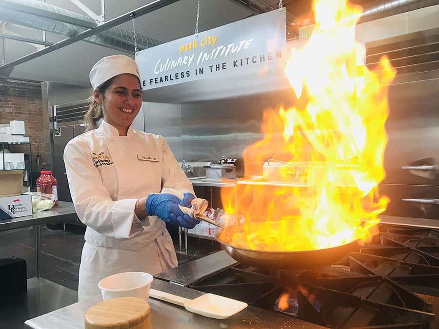 A Park City Culinary Institute learning to flambé.