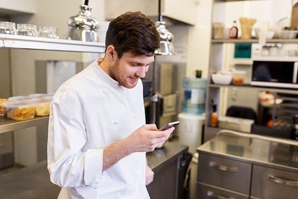 Chef looking at his smartphone.