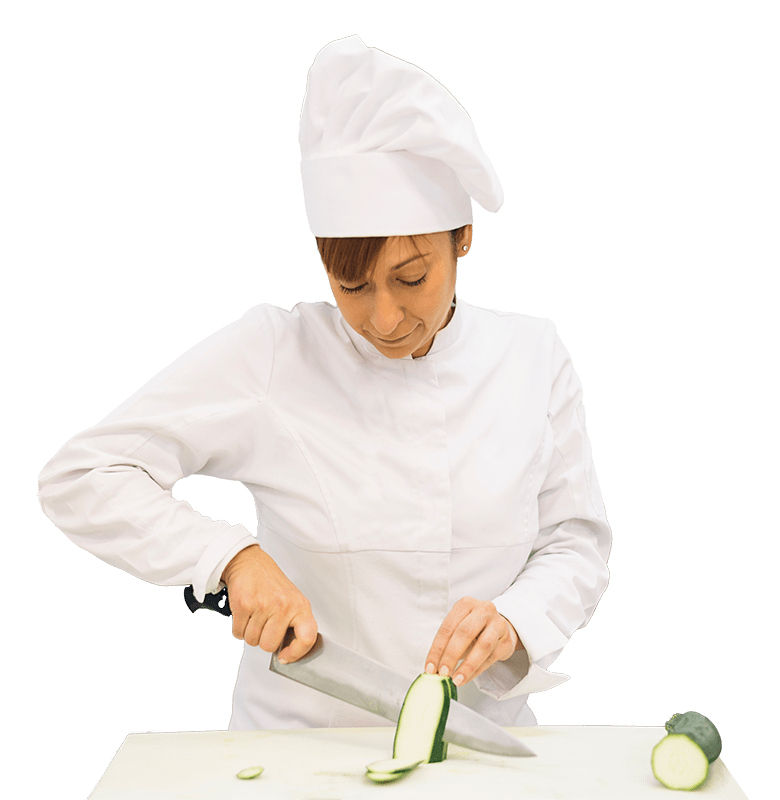 A female chef thinly slicing cucumbers on a cutting board.