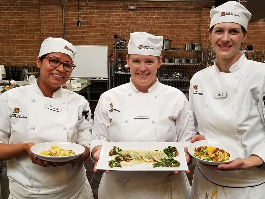 Park City Culinary Institute students showing off dishes they've made.