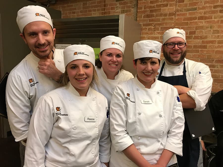 A group of Park City Culinary Institute students, posing and smiling.