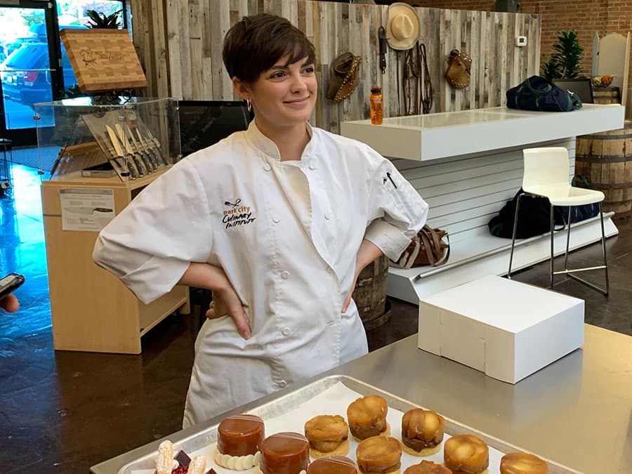 A Park City Culinary Institute chef instructor proudly displaying her pastries.